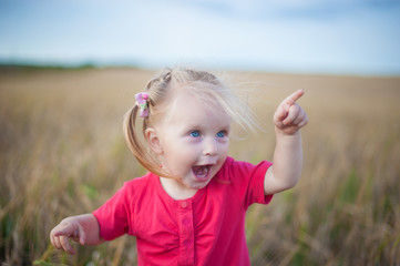 The child having fun playing in a rye field
