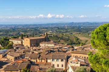 Fototapeta na wymiar San Gimignano, Italy. Scenic view of the medieval town (UNESCO) and the Church of St. Augustine (Chiesa di Sant'Agostino), 1298