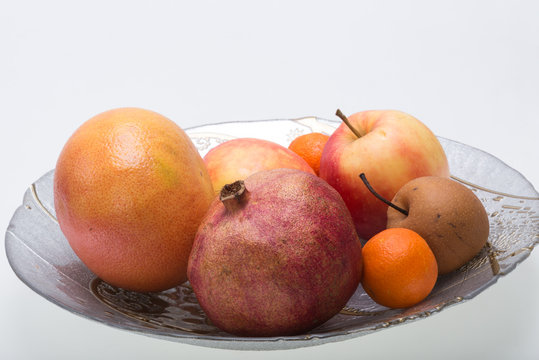 mix fresh fruits on plate isolated on white