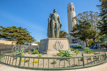 The statue of Christopher Columbus and Coit Tower. People lined up to climb the tower to see the city of San Francisco to 365 degrees. North Beach, on Telegraph Hill, California, United States.