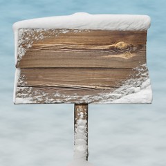 Wooden sign with snow on it and snow bg