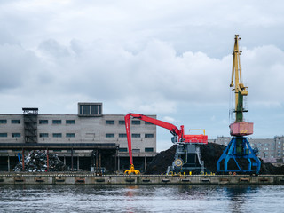 Shipping yard, forklifts near the water, crane