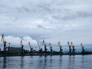 Shipping yard, forklifts near the water, crane