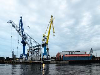 Shipping yard, forklifts near the water, crane