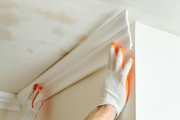 Installation of ceiling moldings.