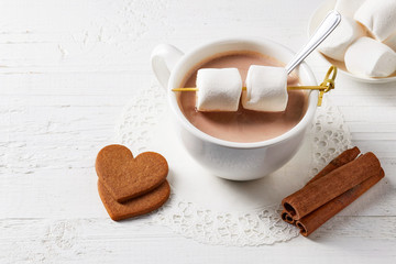 Cup of hot cocoa drink with sweets