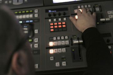 TV editor working with audio video mixer in a television broadca