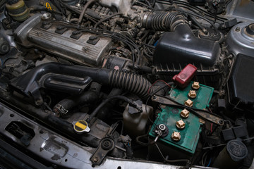Old and dirty car engine in the garage.