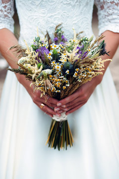 Bouquet Dried Flowers In Hands Of Bride
