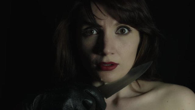 4k shoot of a woman in studio and a hand with knife