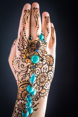 mehendi on hands on a black background