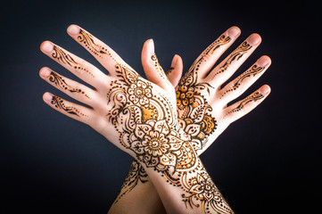 mehendi on hands on a black background