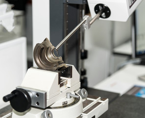operator inspection automotive part by contour measuring machine