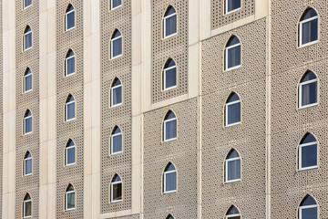 a front of an oriental house with many typic windows 