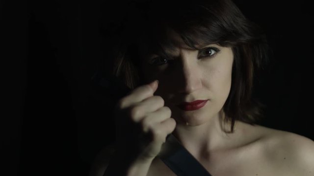 4k shoot of a woman in studio showing her knife