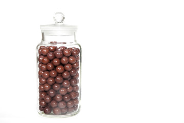 Vintage sweet shop jar full of retro aniseed ball sweets