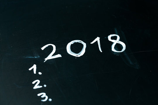 inscription 2018 do it list drawn with chalk on a school blackboard dark