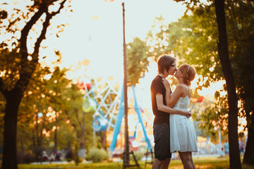 Fototapeta premium guy and the girl hugging at amusement background