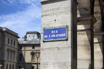 View of a street sign in Paris with dramatic shadows in the background.