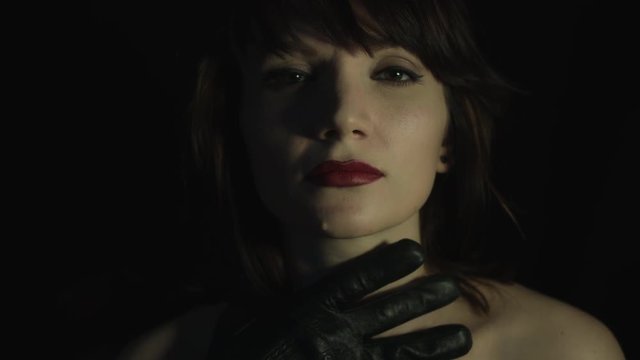 4k shoot of a woman in studio with a hand trying to choke