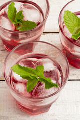 glasses with red drink and ice closeup