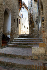 Fototapeta na wymiar Narrow street and stairs in San Gimignano in Tuscany, Italy.