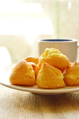 vanilla Choux Cream on dish and coffee cup
