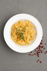 pasta bows on a gray background