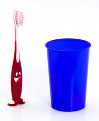 Toothbrushes in glass isolated on white