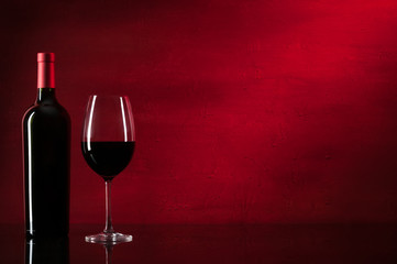 Bottle of red wine and glass