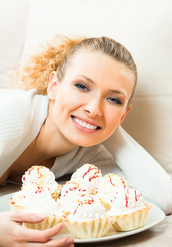 woman with plate of cakes at home