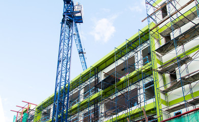 Fototapeta premium Construction site with cranes on sky background