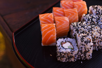Japanese sushi rolls filadelfia on black stone outdoor