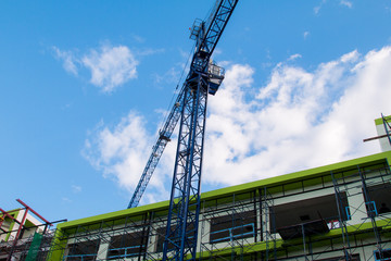 Construction site with cranes on sky background