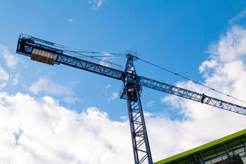 Construction site with cranes on sky background