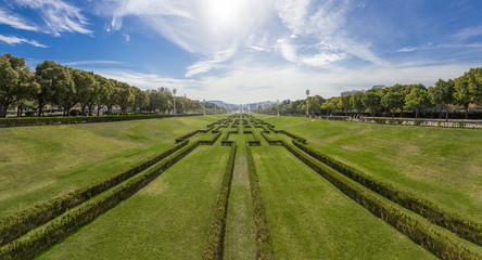 Eduardo VII Park in Lisbon, Portugal, decorated with hedges. View of the city center and downtown from the scenic overlook or vista point built on the top.