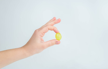 Grapes in a woman's hand on a white background