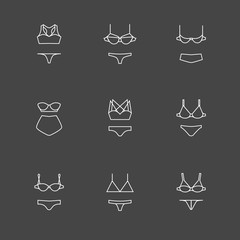 White line bra and panties icons set on black