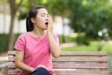 Woman yawning at garden