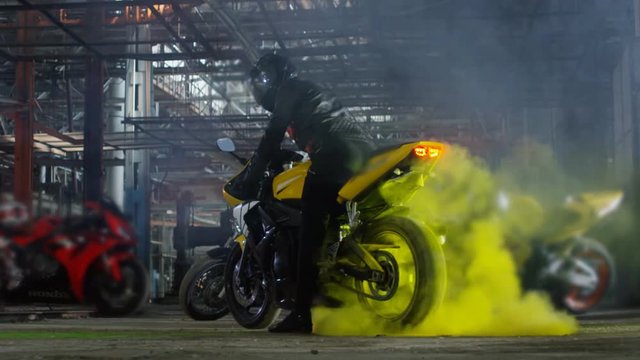 Super sport motorcycle doing a tire burnout with colorful sand, holi. Shot on RED EPIC Cinema Camera in slow motion.