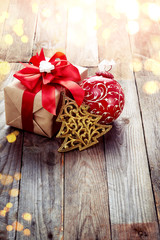 Fototapeta na wymiar Christmas decoration (box,origami christmas tree) over wooden ba