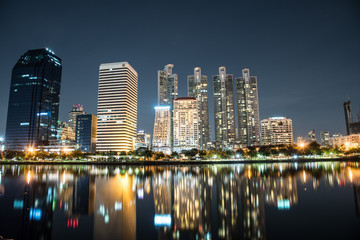 Obraz na płótnie Canvas Bangkok city downtown at night with reflection of skyline, Bangk