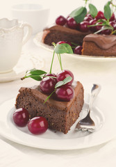 Chocolate cake with cherries and ganache cream.