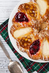 Danish Pastry Ring with Cherry, Apple fruit and Cheese fillings. Selective focus.