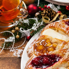 Fototapeta na wymiar Christmas Background Baking Dessert. Danish Pastry Ring with Cherry, Apple fruit and Cheese fillings. Selective focus.