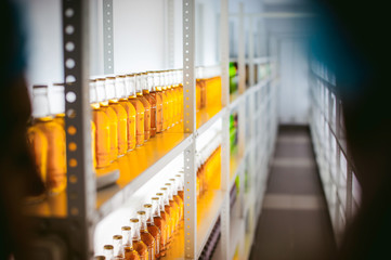 beer bottles on the shelves. many beer bottles standing in a line filled with alcohol on the...