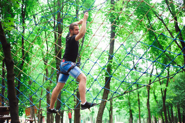 Hiking in the rope park beautiful sports guy