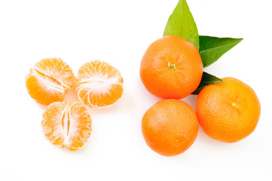 Ripe mandarins with leaves close-up on a white background. Tange