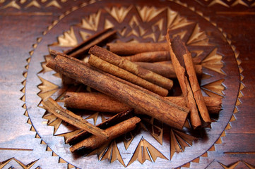 Cinnamon sticks at wooden background