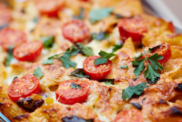 Macaroni casserole with tomatoes and cheese.